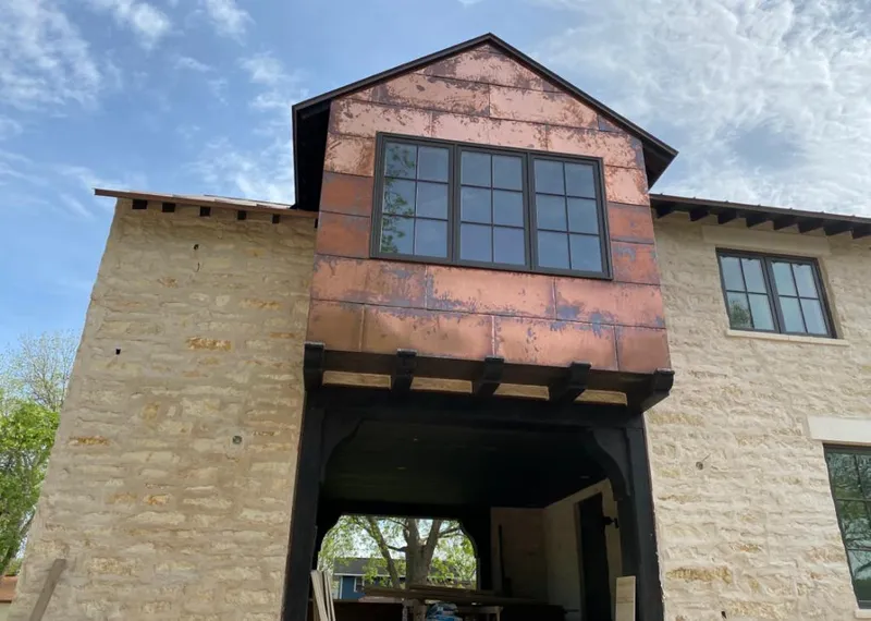 Copper metal panel facade on a stone building for Roof Repair in Paw Paw
